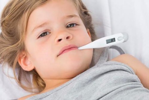 Et sykt barn med et termometer i munnen
